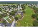 Aerial view of golf course and community amenities with well-manicured greens at 7506 Moriah Ave, Brooksville, FL 34613