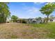 Beautiful backyard featuring a well-maintained lawn, mature trees, and landscaping at 7506 Moriah Ave, Brooksville, FL 34613
