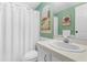 Bathroom with a white shower curtain, vanity, toilet, and a mural of a window with a view at 7506 Moriah Ave, Brooksville, FL 34613