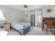 Bright bedroom features a ceiling fan, closet, and a sliding glass door for natural light at 7506 Moriah Ave, Brooksville, FL 34613