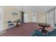 Enclosed carpeted porch with furniture and a doorway to the exterior at 7506 Moriah Ave, Brooksville, FL 34613