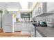 Bright kitchen with white cabinets, appliances, and a view from the window at 7506 Moriah Ave, Brooksville, FL 34613