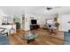 Inviting living room with wood flooring, ceiling fan, and bar seating in the background at 7506 Moriah Ave, Brooksville, FL 34613