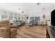 Bright living room features hardwood floors, large windows, and comfortable seating at 7506 Moriah Ave, Brooksville, FL 34613