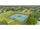 Aerial view of well-maintained community tennis courts and surrounding neighborhood at 7506 Moriah Ave, Brooksville, FL 34613