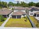 Aerial view of a fenced backyard with a well-maintained lawn and surrounding neighborhood at 778 Parsons Mooring Ct, Seffner, FL 33584