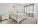 Bright bedroom with white furniture, gray carpet, and a comfortable-looking bed with patterned bedding at 778 Parsons Mooring Ct, Seffner, FL 33584