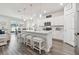 Open kitchen featuring a large island with seating, stainless appliances and hardwood floors at 778 Parsons Mooring Ct, Seffner, FL 33584