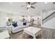 Spacious open-concept living area with modern hardwood floors, seamlessly flowing into the kitchen at 778 Parsons Mooring Ct, Seffner, FL 33584