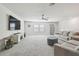 Spacious living room features plush carpeting, neutral tones, and a comfortable seating area at 778 Parsons Mooring Ct, Seffner, FL 33584