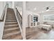 Open living room with hardwood floors, stairs, and a stylish white entertainment center at 778 Parsons Mooring Ct, Seffner, FL 33584