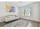Cozy living room with hardwood floors, a comfortable couch, and natural light filtering in through the window at 778 Parsons Mooring Ct, Seffner, FL 33584