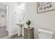 Powder room showcasing a pedestal sink, modern toilet, and small cabinet, with updated fixtures at 778 Parsons Mooring Ct, Seffner, FL 33584
