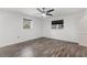 This bedroom features new floors, a ceiling fan, and two large windows for ample light at 8364 Eldridge Rd, Spring Hill, FL 34608