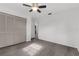 Bright bedroom featuring wood-look flooring, ceiling fan, and spacious closet at 8364 Eldridge Rd, Spring Hill, FL 34608