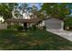 Charming single-story home with a well-manicured lawn, mature trees, and a two-car garage at 8364 Eldridge Rd, Spring Hill, FL 34608