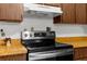 This kitchen features wooden cabinets, stainless steel range and appliances, and light countertops at 8364 Eldridge Rd, Spring Hill, FL 34608