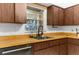 Kitchen view showing the stainless steel appliances, undermount sink and faucet, and wooden cabinets at 8364 Eldridge Rd, Spring Hill, FL 34608