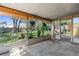 Enclosed patio showing view of the backyard with mature trees and lawn at 8364 Eldridge Rd, Spring Hill, FL 34608