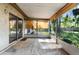 Enclosed patio with bamboo shades overlooking the backyard at 8364 Eldridge Rd, Spring Hill, FL 34608