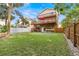 Expansive backyard features lush lawn and a two-story home with outdoor decks overlooking the yard at 856 Wisconsin Ave, Palm Harbor, FL 34683