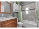 Updated bathroom with white cabinets, granite countertop, and tiled shower and tub at 856 Wisconsin Ave, Palm Harbor, FL 34683
