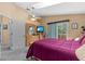 A bedroom with a ceiling fan, balcony, and a dresser with TV at 856 Wisconsin Ave, Palm Harbor, FL 34683