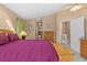 This bedroom is decorated with warm earth tones and private access to the bathroom and stairwell at 856 Wisconsin Ave, Palm Harbor, FL 34683