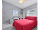 Bedroom with two large windows, ceiling fan, and plenty of space at 856 Wisconsin Ave, Palm Harbor, FL 34683