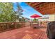 Spacious wooden deck with outdoor seating and grilling area, perfect for entertaining with neighborhood views at 856 Wisconsin Ave, Palm Harbor, FL 34683