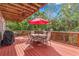 Large outdoor deck includes table, chairs, grill, and umbrella, perfect for outdoor entertaining at 856 Wisconsin Ave, Palm Harbor, FL 34683