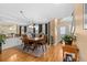 Spacious dining room with wood floors, adjacent to living area and staircase at 856 Wisconsin Ave, Palm Harbor, FL 34683