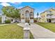 Beautiful home with two-car garage, staircase to front door, and lush green lawn at 856 Wisconsin Ave, Palm Harbor, FL 34683