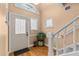 Inviting foyer with hardwood floors, staircase, and a decorative arched window at 856 Wisconsin Ave, Palm Harbor, FL 34683