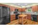 Well-equipped kitchen with stainless steel appliances, wood cabinets, and an island at 856 Wisconsin Ave, Palm Harbor, FL 34683
