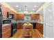 Charming kitchen featuring wood cabinets, granite countertops, and modern appliances at 856 Wisconsin Ave, Palm Harbor, FL 34683