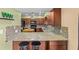 A view of the kitchen featuring granite countertops and modern appliances at 856 Wisconsin Ave, Palm Harbor, FL 34683