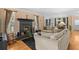 Relaxing living room with a fireplace, hardwood floors, and comfortable sofas at 856 Wisconsin Ave, Palm Harbor, FL 34683