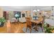 Open-concept living room with hardwood floors, fireplace, and access to outdoor deck at 856 Wisconsin Ave, Palm Harbor, FL 34683