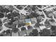 Aerial view highlighting a house with a bright blue roof and green lawn within a residential neighborhood at 8705 Village Mill Row, Hudson, FL 34667