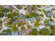 Aerial view showing the neighborhood layout, mature trees, and proximity to community amenities at 8705 Village Mill Row, Hudson, FL 34667