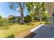Well-maintained backyard featuring mature trees and lush landscaping at 8705 Village Mill Row, Hudson, FL 34667