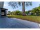 Spacious backyard featuring a large tree and a mix of landscaping, offering a serene outdoor space at 8705 Village Mill Row, Hudson, FL 34667
