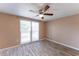 Bedroom with a sliding glass door for natural light, ceiling fan, and wood-look tile floor at 8705 Village Mill Row, Hudson, FL 34667