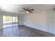 Bright bedroom with tile floor leading to a screened porch with backyard view at 8705 Village Mill Row, Hudson, FL 34667