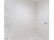 A walk-in closet with white door, tile flooring and wire shelving at 8705 Village Mill Row, Hudson, FL 34667