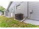 Exterior view of the home showcasing the well-maintained siding and installed Bryant HVAC system at 8705 Village Mill Row, Hudson, FL 34667