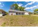 Well-maintained one-story home with brick facade and a pristine lawn, showcasing its curb appeal at 8705 Village Mill Row, Hudson, FL 34667