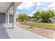 View from a covered front porch with stone groundcover and a glimpse of the neighborhood street at 8705 Village Mill Row, Hudson, FL 34667