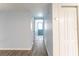Bright hallway featuring light blue walls, wood-look tile floors, and a clear view to a blue front door at 8705 Village Mill Row, Hudson, FL 34667